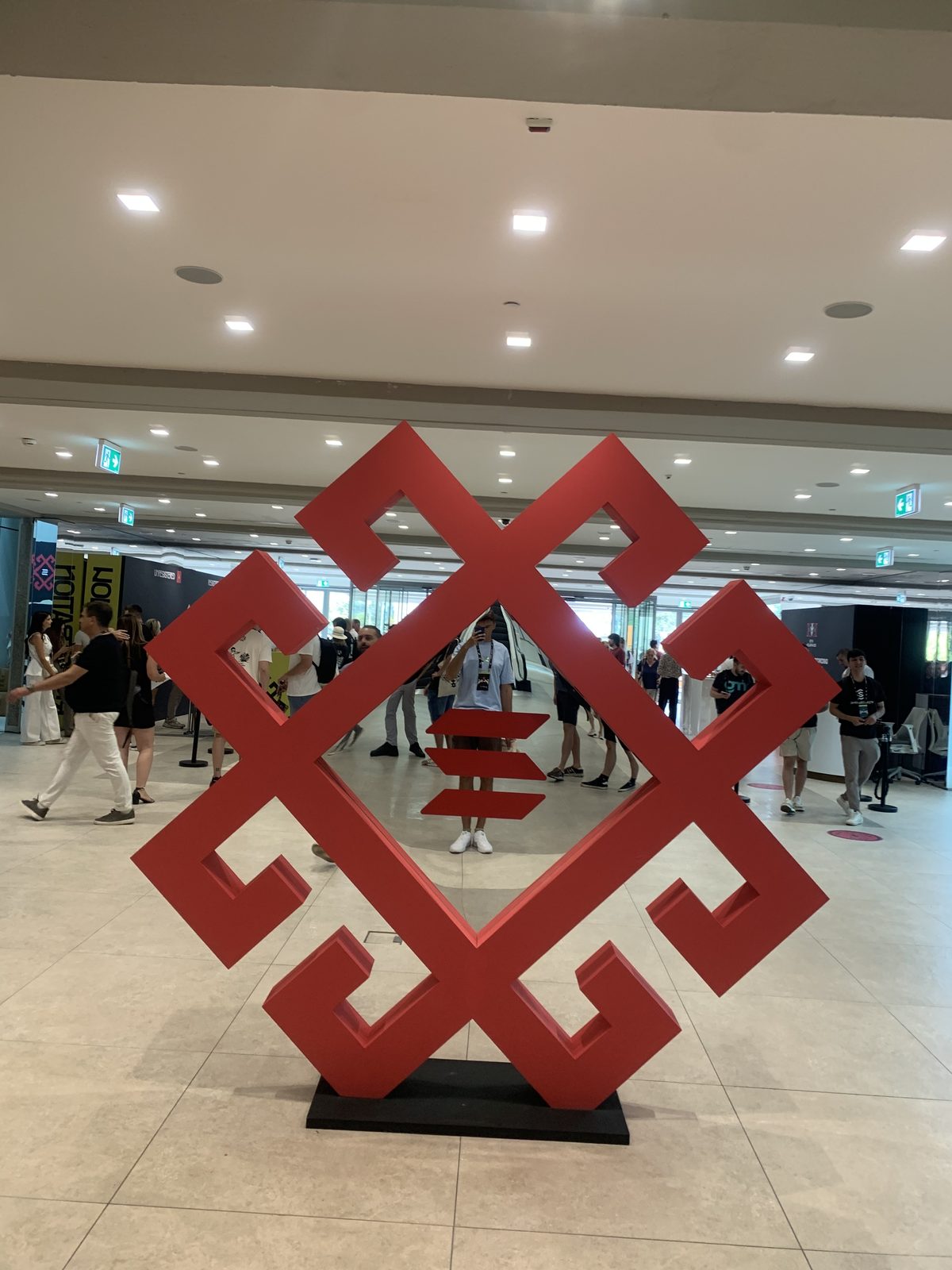 Attendees in the Sava Center foyer around a large red Solana Summit Serbia sculpture