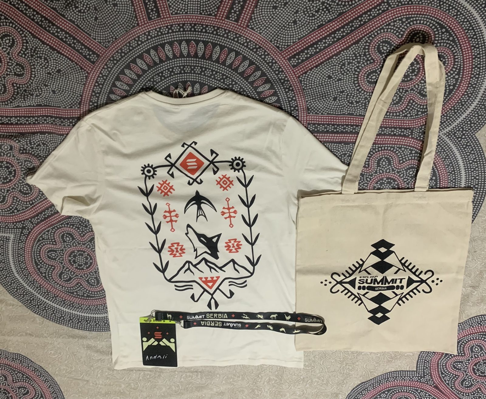 Solana Summit Serbia t-shirt, tote bag and attendee badge on a patterned blanket