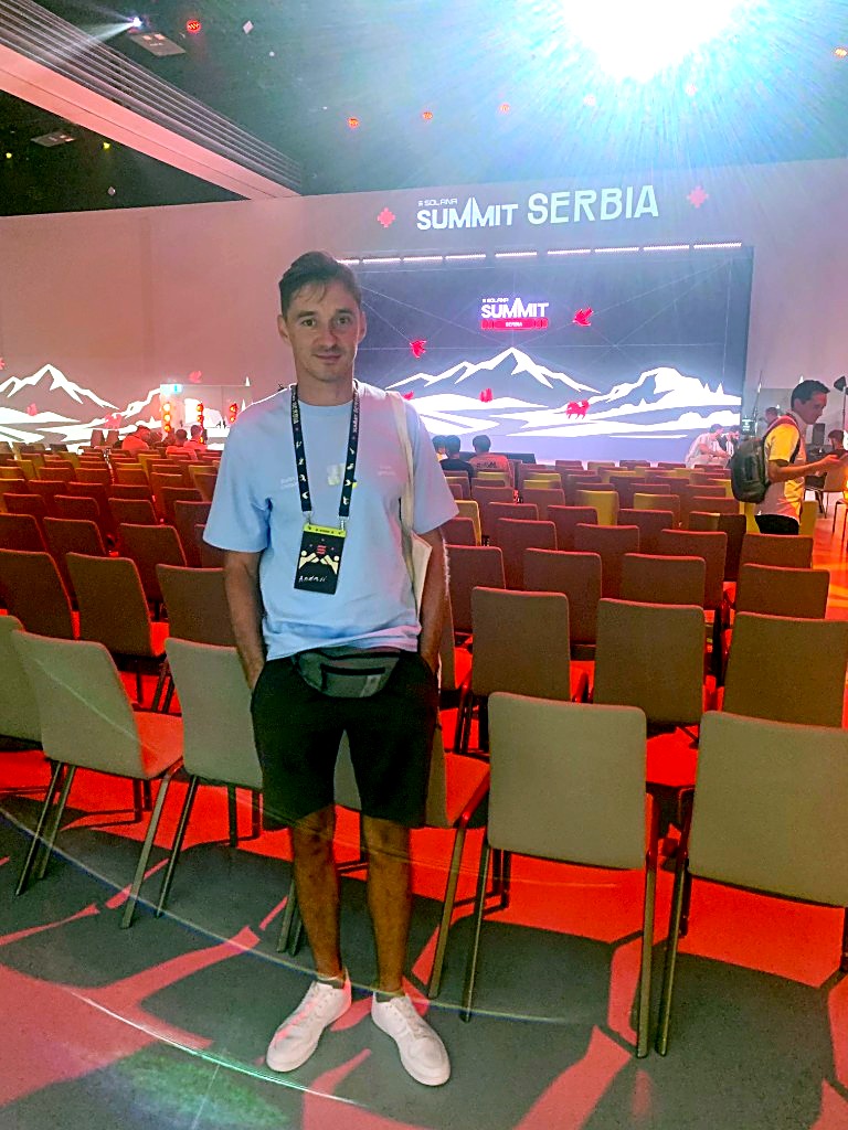Full-length photo of an attendee in the main hall of Solana Summit Serbia in front of the main stage
